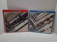 Front covers of both red and blue Beatles compilation LPs
