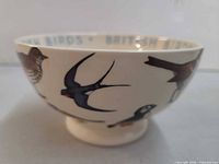 Side view showing bird illustrations and footed base