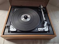 Top view of Dual 1015 turntable in wood case showing platter and tonearm