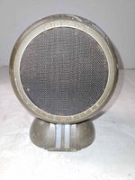 Front view showing round grille and branding