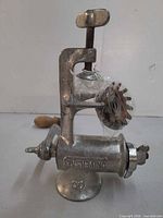 Side view of grinder showing Universal 00 casting, clamp base, wood handle