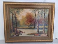 Full view of framed oil landscape painting