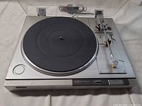 Full view of Sony PS-LX210 turntable showing platter, tonearm, dust cover, power cord
