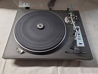 Top view of Toshiba SR-250 turntable showing platter, tonearm, controls and dust cover