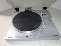 Top view of Yamaha P-550 turntable with dust cover open showing platter and tonearm