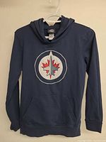 Full view of navy Winnipeg Jets youth hoodie on hanger