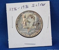 Obverse of 1776-1976 Kennedy half dollar in cardboard flip