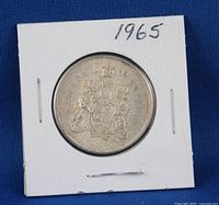 Reverse view showing Canadian Coat of Arms within 2×2 holder