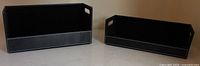 Both black leather desk trays front view
