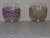 Front view of both decorated wine glasses showing patterns