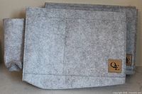 Two gray felt bedside pockets stacked showing front and logo