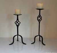 Both wrought iron candle holders with LED candles visible full length