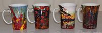 Front view of four McIntosh Tom Thomson grande mugs showing artwork