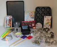 Overview showing pans, utensils, cutter packaging and loose cookie cutters