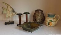 Full lot overview showing fish, spools, basket with candle, jug, metal tray