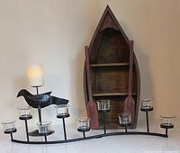 Front view of crow candle holder, boat shelf with paddles and S-curve tealight holder