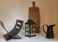 Group view of lantern, magazine rack, serving paddle, pitcher