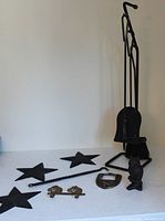 Group shot showing fireplace tools, three star trivets, owl, hooks