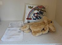 Overall lot showing unstuffed dog body, Poly-Down bag, instruction sheets