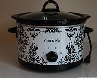 Front view of patterned Crock-Pot showing branding and control dial