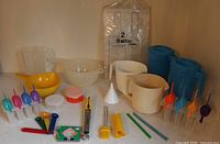 Full lot overview showing pitchers, colander, bowls, popsicle molds, utensils and bubble-wrap sleeve
