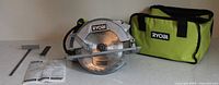 Circular saw with blade attached, rip fence, blade wrench, manual and carry bag