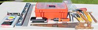 All tools laid out including closed Black & Decker case, level, saw, hand tools, hardware