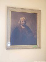 Full view of framed portrait print on wall