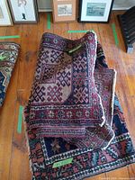 Stacked rugs showing overall patterns and colours