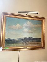 Framed landscape painting with accent light