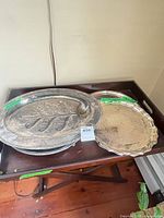 Two trays stacked: oval tree meat platter and round scalloped platter