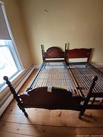Complete bed frame showing headboard, footboard, posts and metal spring base