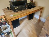 Front view of solid wood table desk with equipment on top