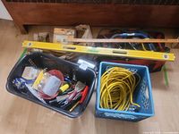 Overall view showing baskets, long level, variety of tools and extension cord