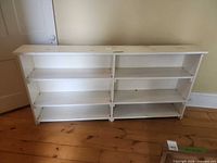 Front view of entire white bookcase showing six shelves