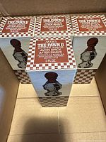 Three boxed Avon The Pawn II bottles inside shipping box