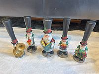 Five J Adams 1994 caroler figurines standing in line displaying instruments and accessories