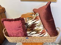 Basket holding four decorative pillows
