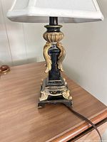 Full view of lamp showing base, column, shade and cord