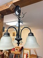 Full view of fixture showing three shades, frame, wiring