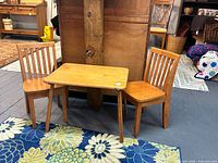 Child-size wooden table and two matching chairs