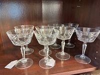 Front view of all 8 glasses on shelf