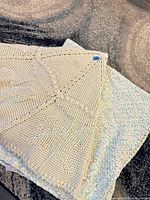 Folded view of both afghans showing textures and colors