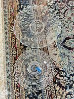 Both clear pressed glass platters displayed on rug