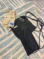 All three bags laid out: beige crochet with toggles, black crochet with strap, black satin beaded bag