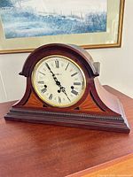 Front view of Howard Miller mantel clock showing dial, bezel, case shape