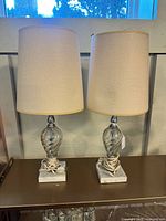 Front view of both matching glass lamps with shades