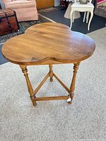 Overall view of Ethan Allen cloverleaf end table showing top shape, legs and stretcher