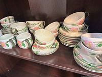 Franciscan Rose cups and saucers stacked on shelf