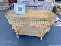 oval wicker coffee table with picture frame on top
